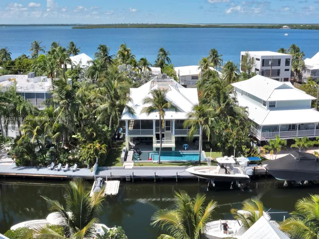 a view of swimming pool with outdoor seating and lake view
