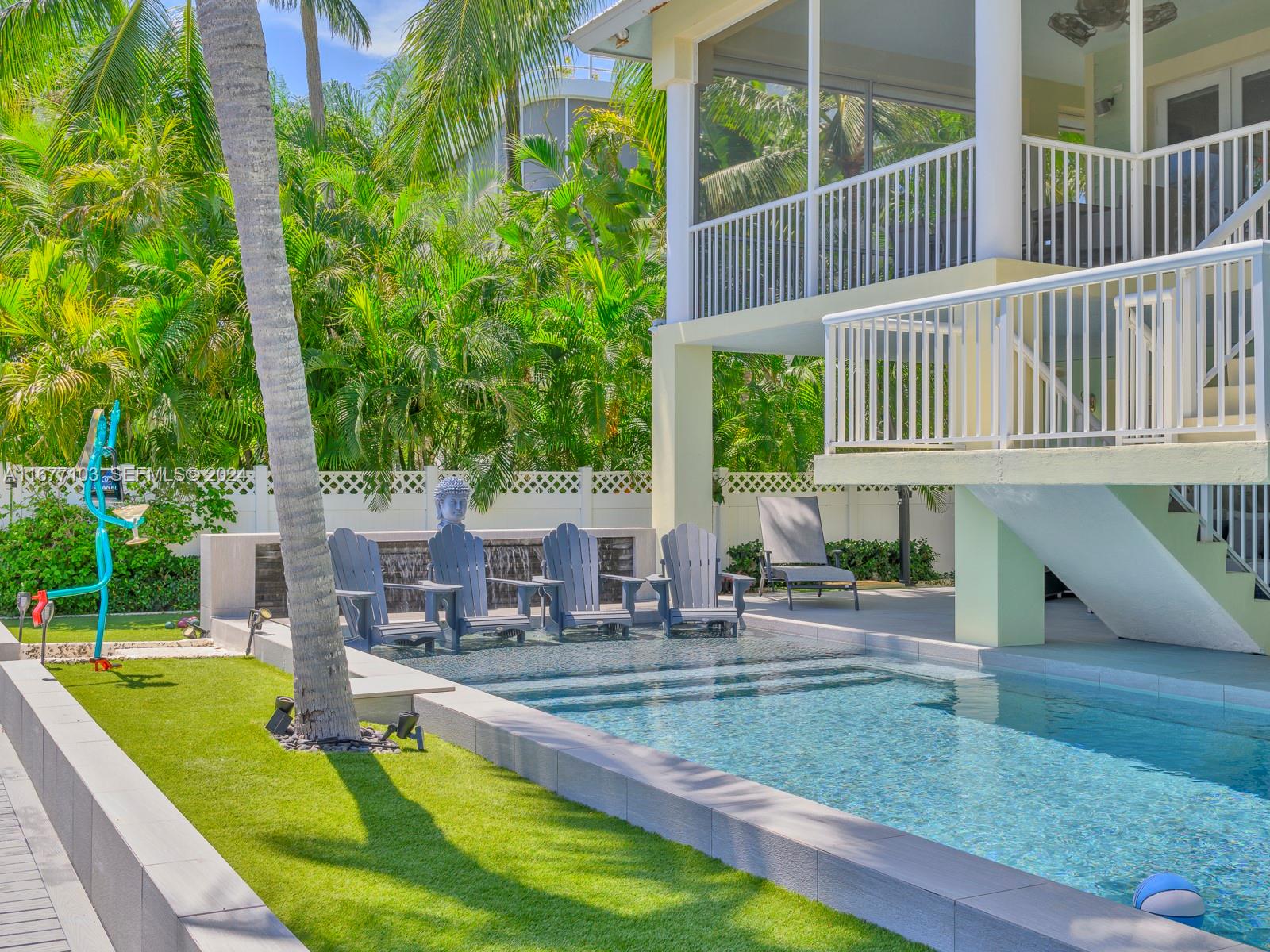 3 North Drive Key Largo, FL 33037 - Photo 10 of 54 a view of swimming pool with lawn chairs and plants