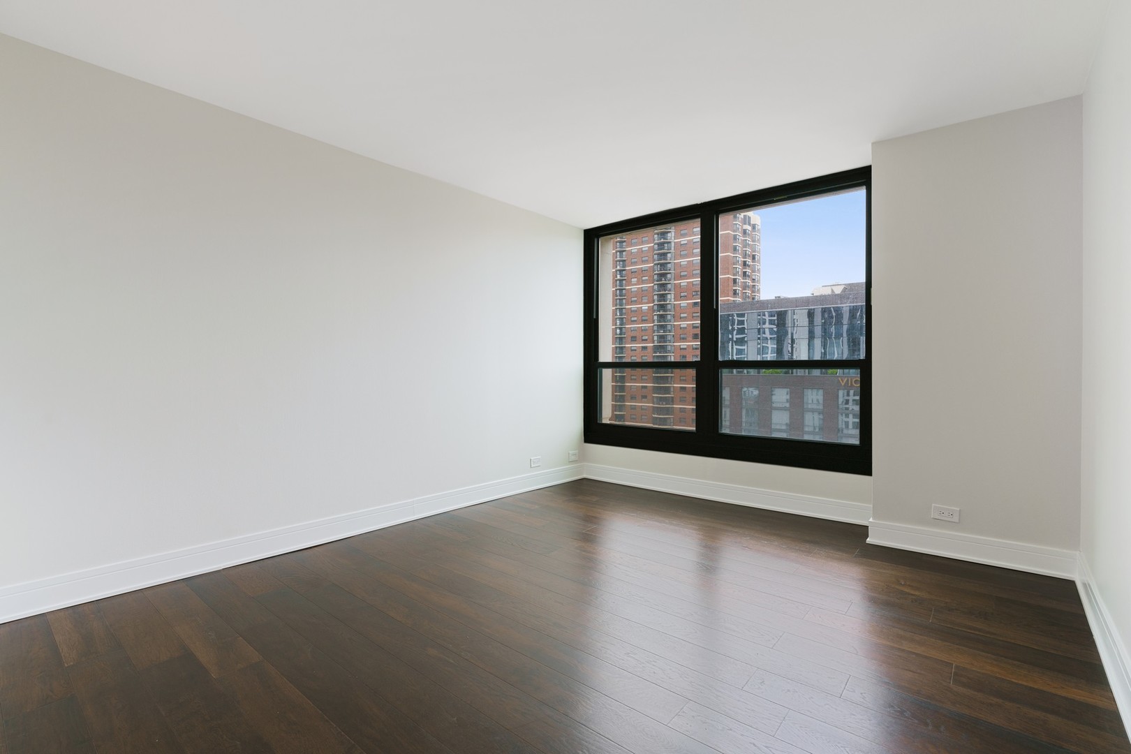 1030 North State Street, Unit 13E Chicago, IL 60610 - Photo 11 of 30 an empty room with wooden floor and windows