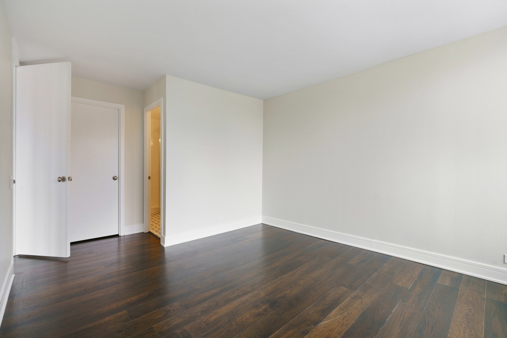 1030 North State Street, Unit 13E Chicago, IL 60610 - Photo 13 of 30 a view of an empty room with wooden floor