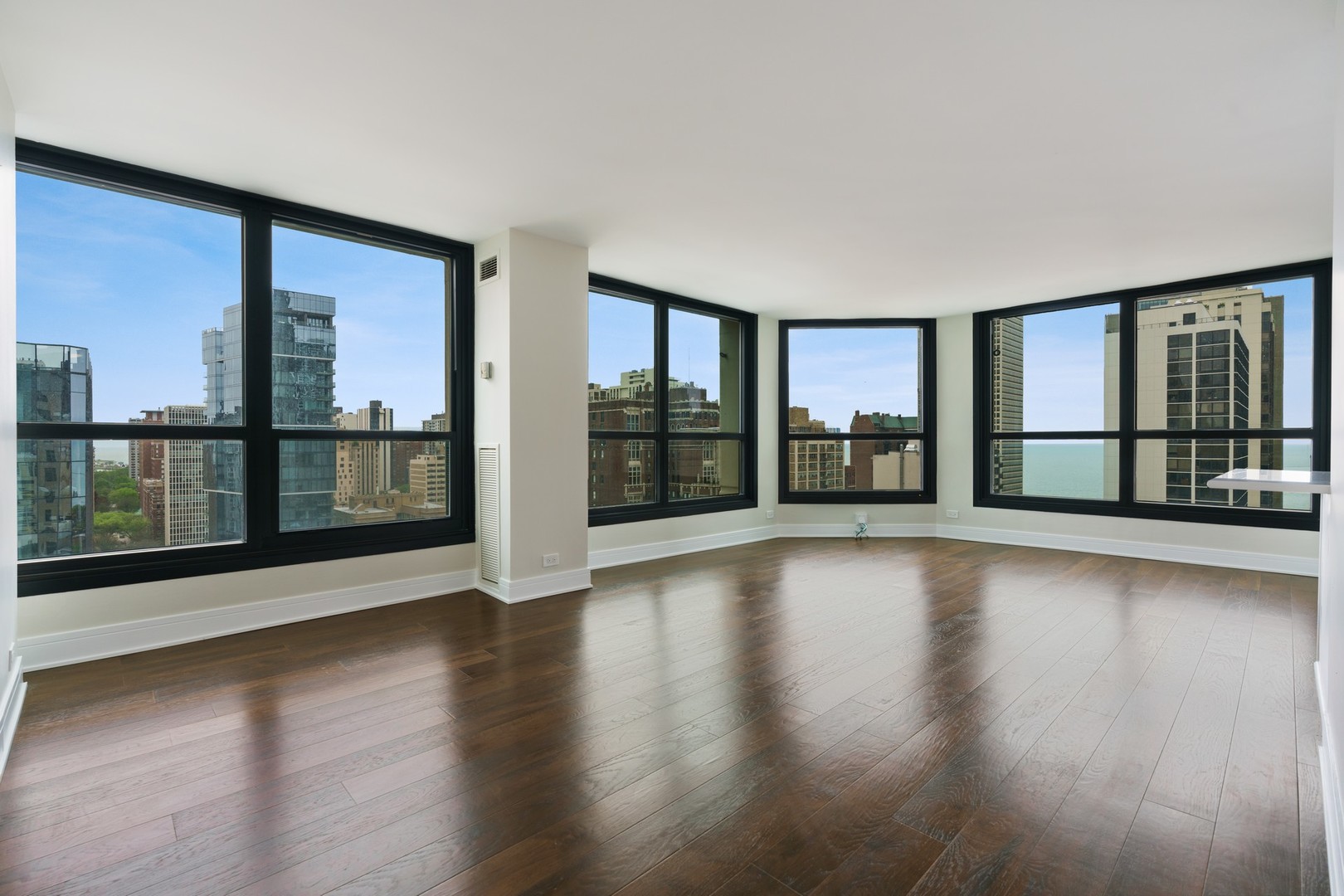 1030 North State Street, Unit 13E Chicago, IL 60610 - Photo 2 of 30 a view of an empty room with wooden floor and a window