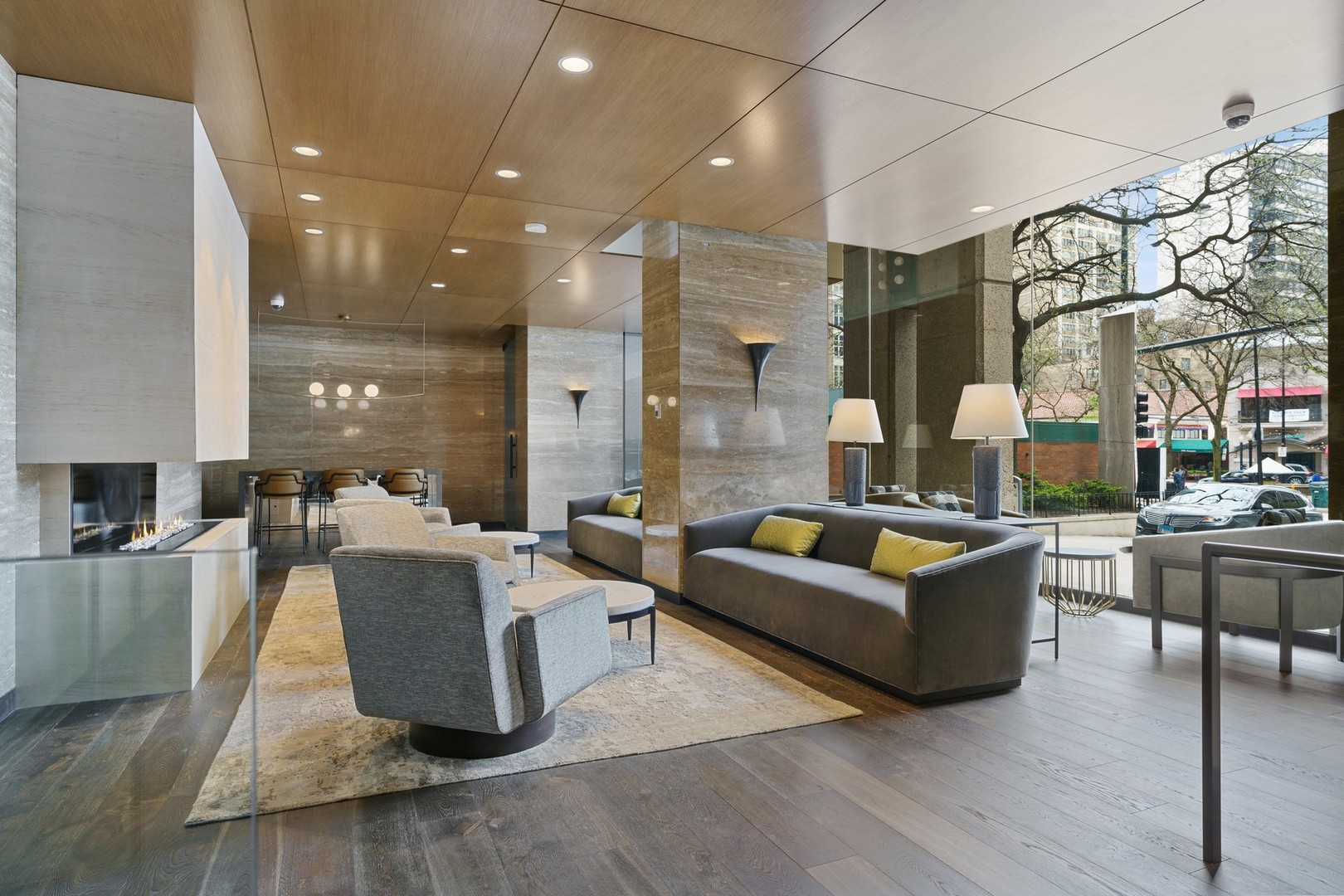 1030 North State Street, Unit 13E Chicago, IL 60610 - Photo 27 of 30 a living room with couches and kitchen view with wooden floor