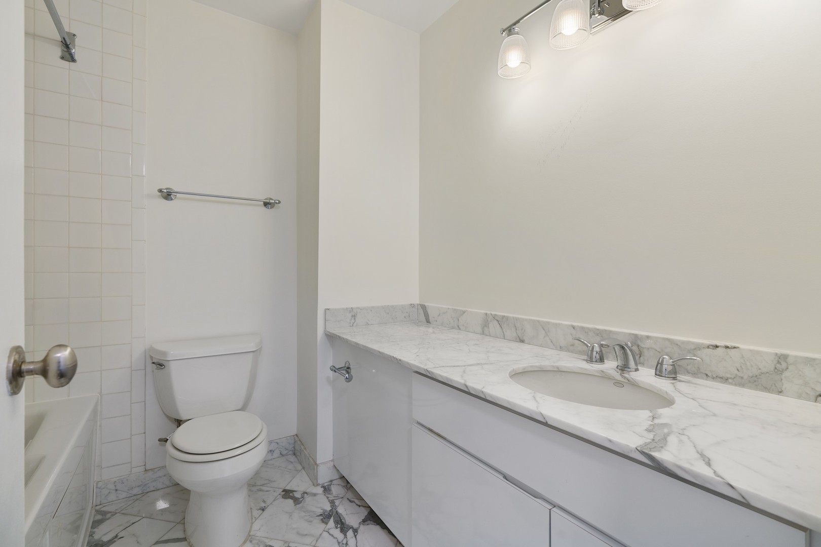 1030 North State Street, Unit 13E Chicago, IL 60610 - Photo 30 of 30 a bathroom with a granite countertop toilet and a sink