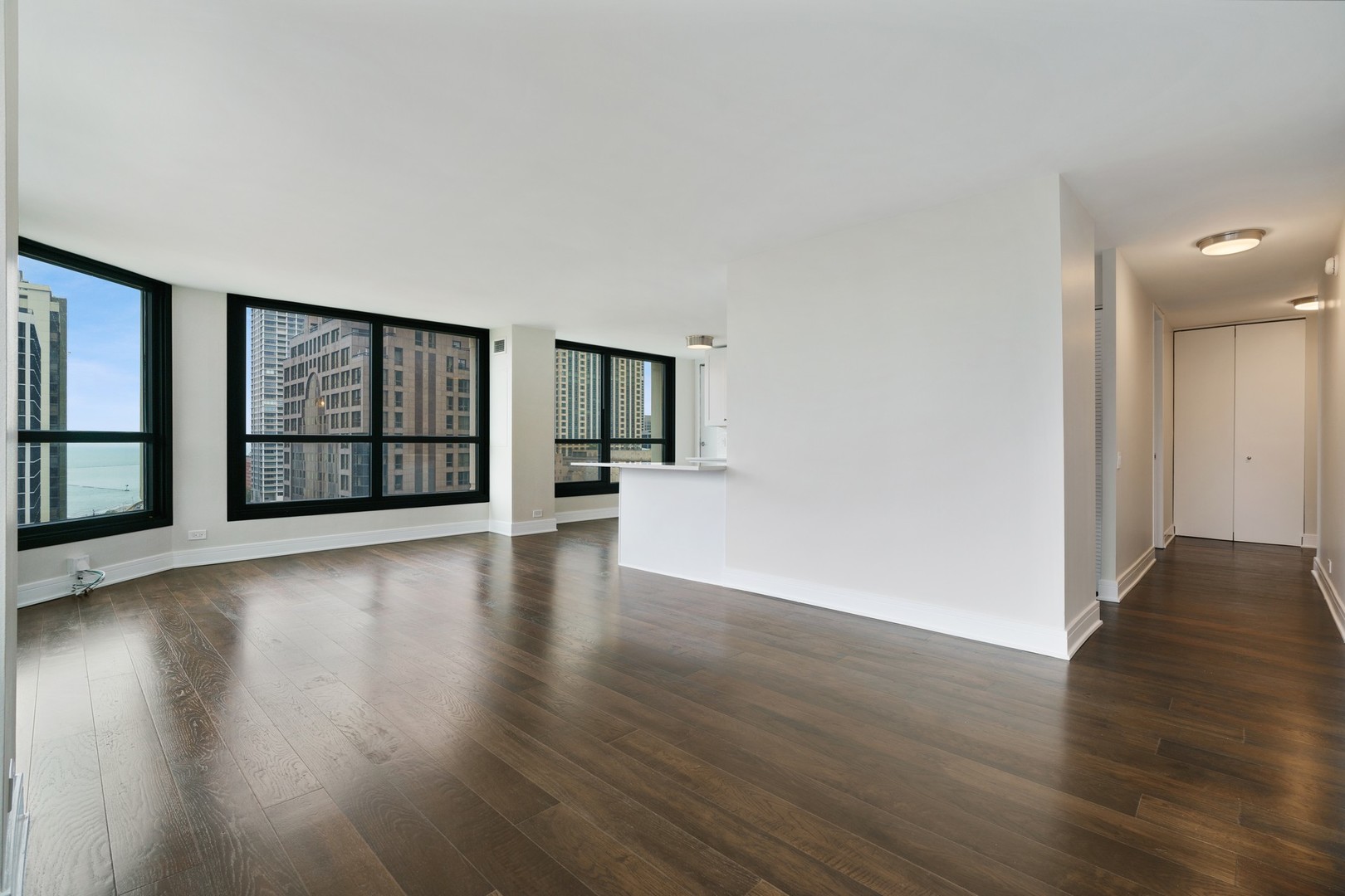 1030 North State Street, Unit 13E Chicago, IL 60610 - Photo 3 of 30 a view of an empty room with wooden floor and a window