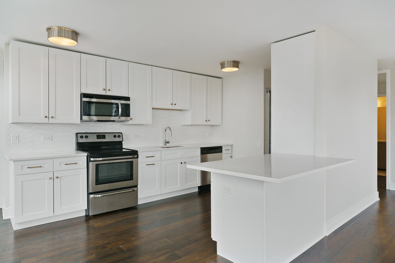 1030 North State Street, Unit 13E Chicago, IL 60610 - Photo 7 of 30 a kitchen with granite countertop white cabinets and stainless steel appliances
