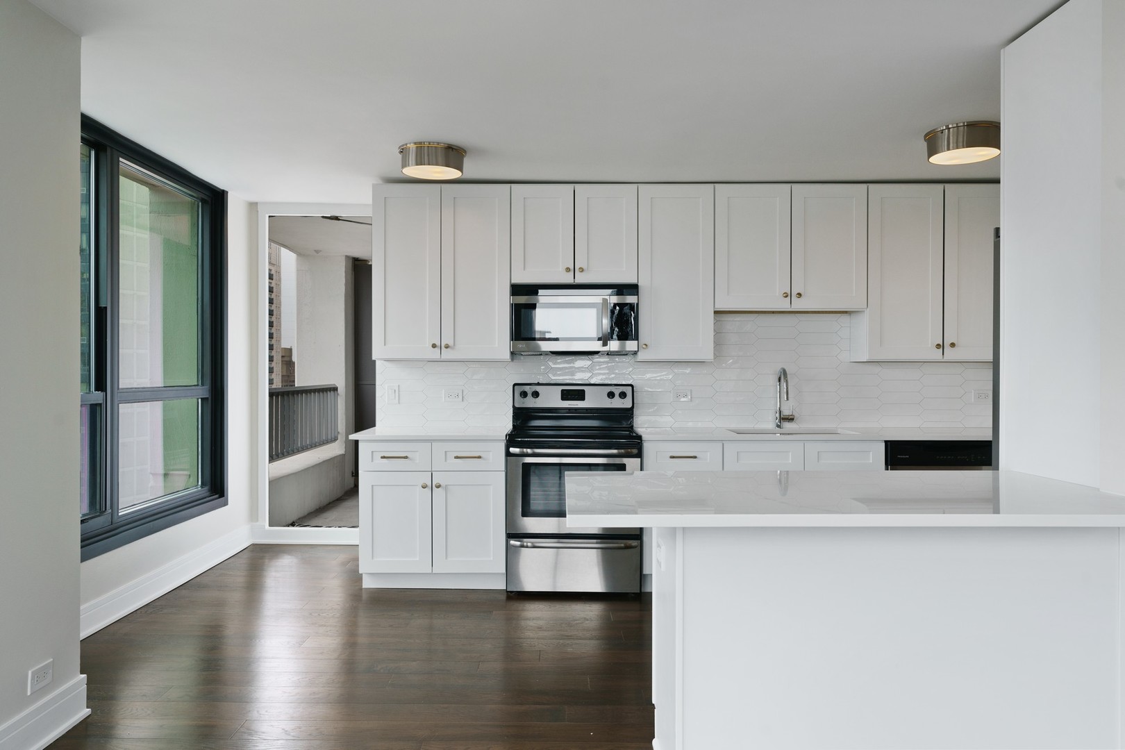 1030 North State Street, Unit 13E Chicago, IL 60610 - Photo 8 of 30 a kitchen with granite countertop white cabinets and stainless steel appliances