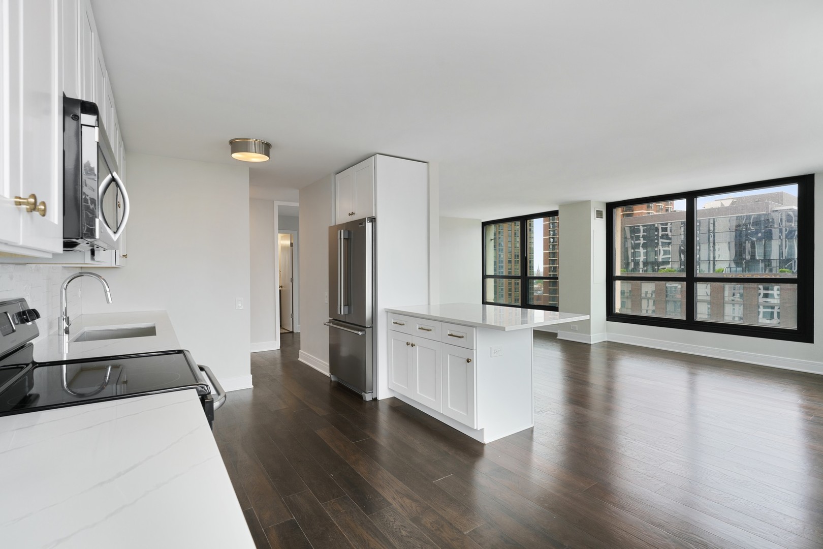 1030 North State Street, Unit 13E Chicago, IL 60610 - Photo 10 of 30 a large white kitchen with sink a refrigerator and a large window