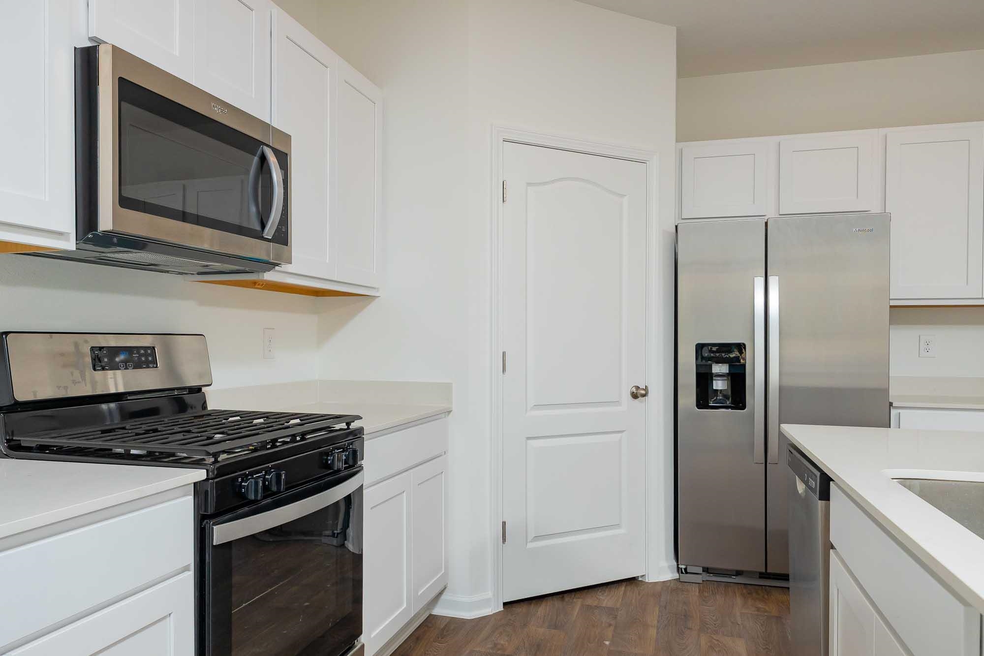 951 Orellana Road St. Augustine, FL 32084 - Photo 16 of 54 a kitchen with stainless steel appliances granite countertop a stove microwave and refrigerator