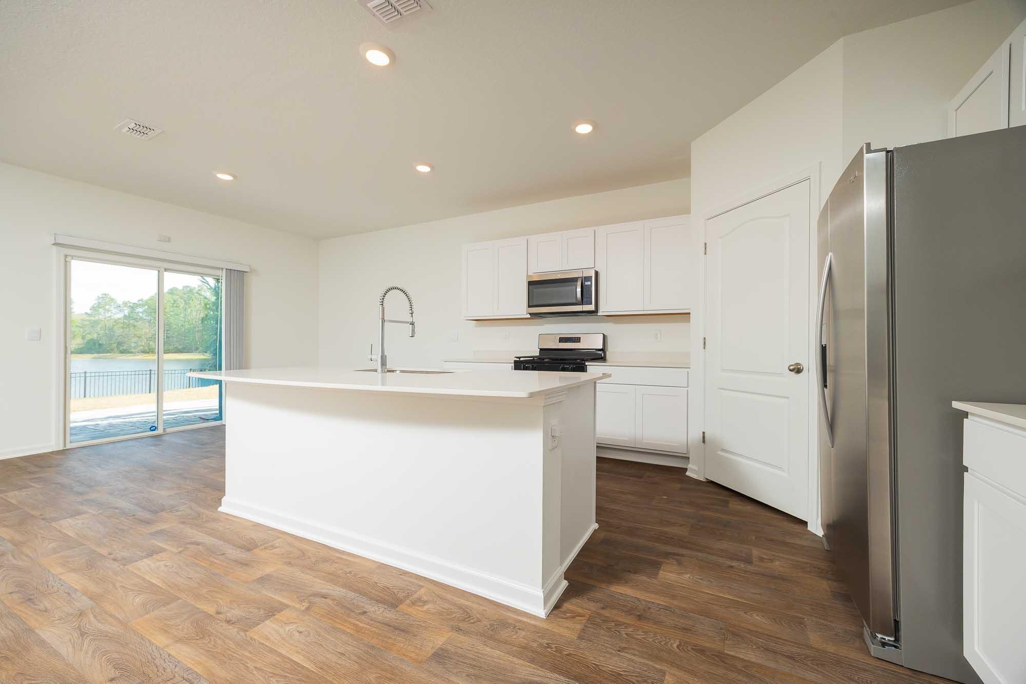 951 Orellana Road St. Augustine, FL 32084 - Photo 30 of 54 a kitchen with stainless steel appliances granite countertop a refrigerator a sink a stove a microwave and a refrigerator