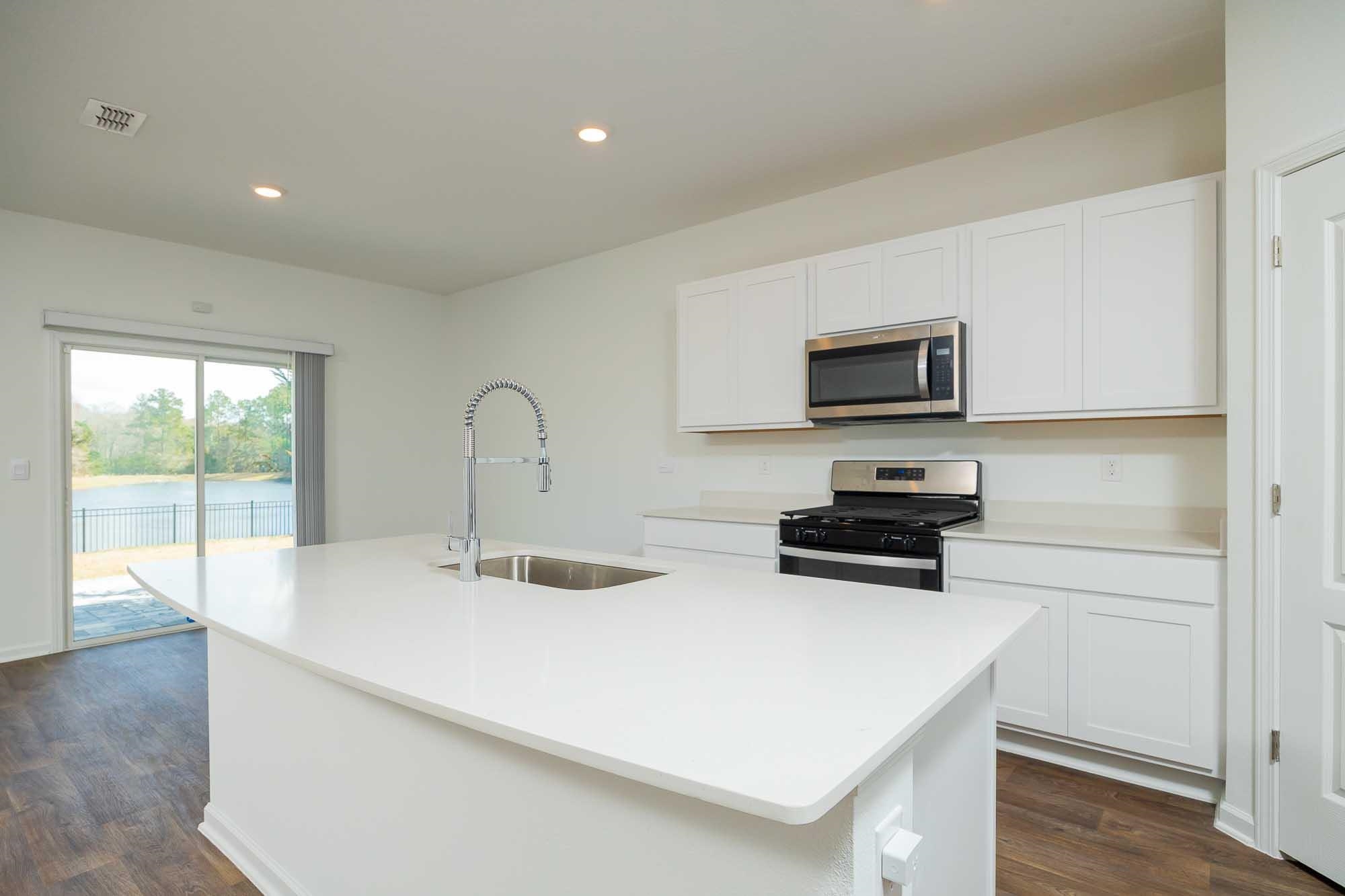 951 Orellana Road St. Augustine, FL 32084 - Photo 31 of 54 a kitchen with a sink a stove and microwave