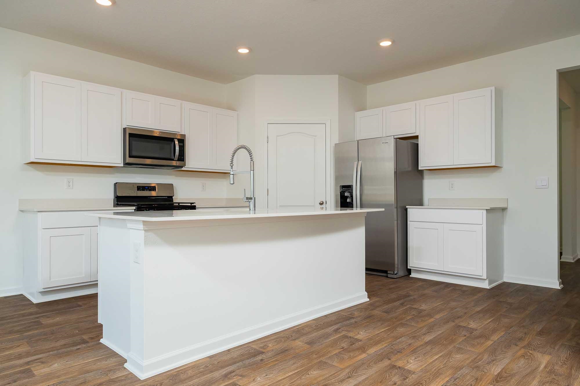 951 Orellana Road St. Augustine, FL 32084 - Photo 32 of 54 a kitchen with a refrigerator a stove top oven a sink and cabinets