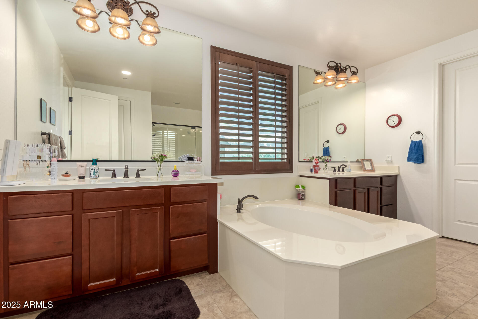 2247 North Beverly Place Buckeye, AZ 85396 - Photo 26 of 95 a bathroom with a tub a double vanity sink and a mirror