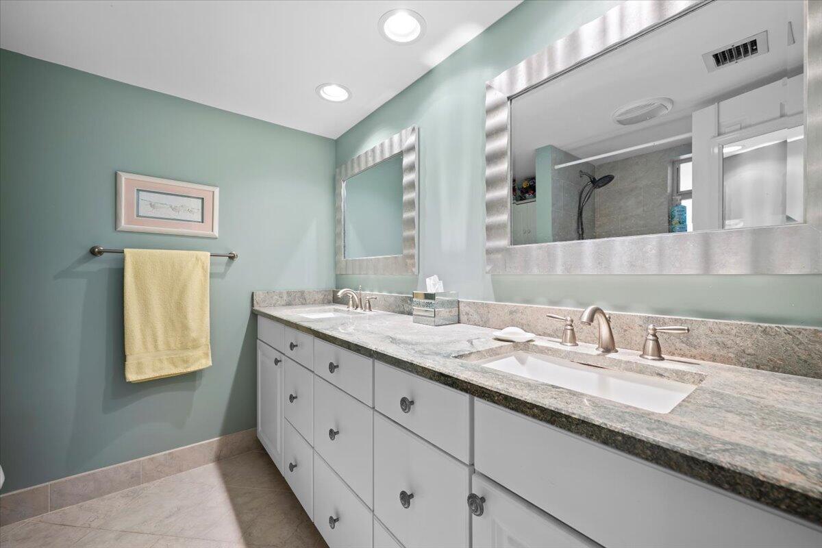 1252 Sugar Sands Boulevard, Unit 137 Riviera Beach, FL 33404 - Photo 22 of 38 a bathroom with a granite countertop double vanity sink and mirror