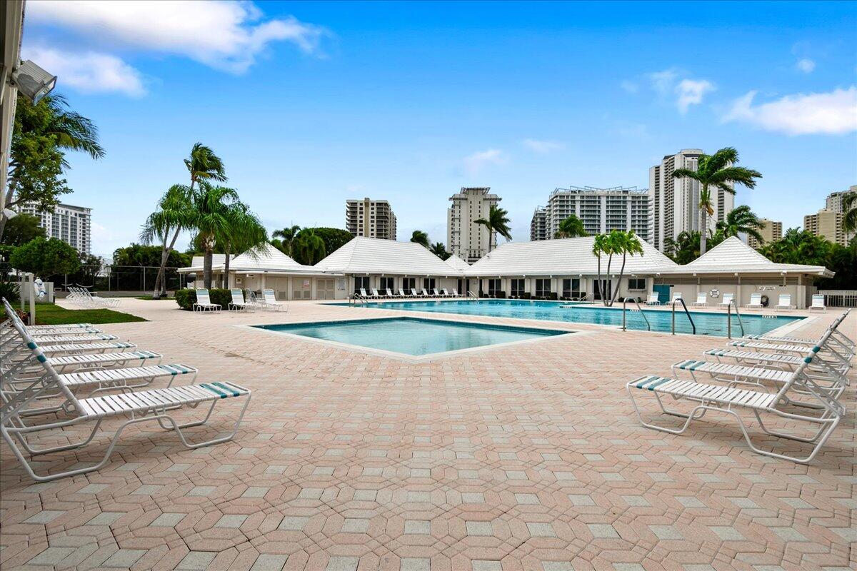 1252 Sugar Sands Boulevard, Unit 137 Riviera Beach, FL 33404 - Photo 37 of 38 a view of swimming pool with outdoor seating and plants