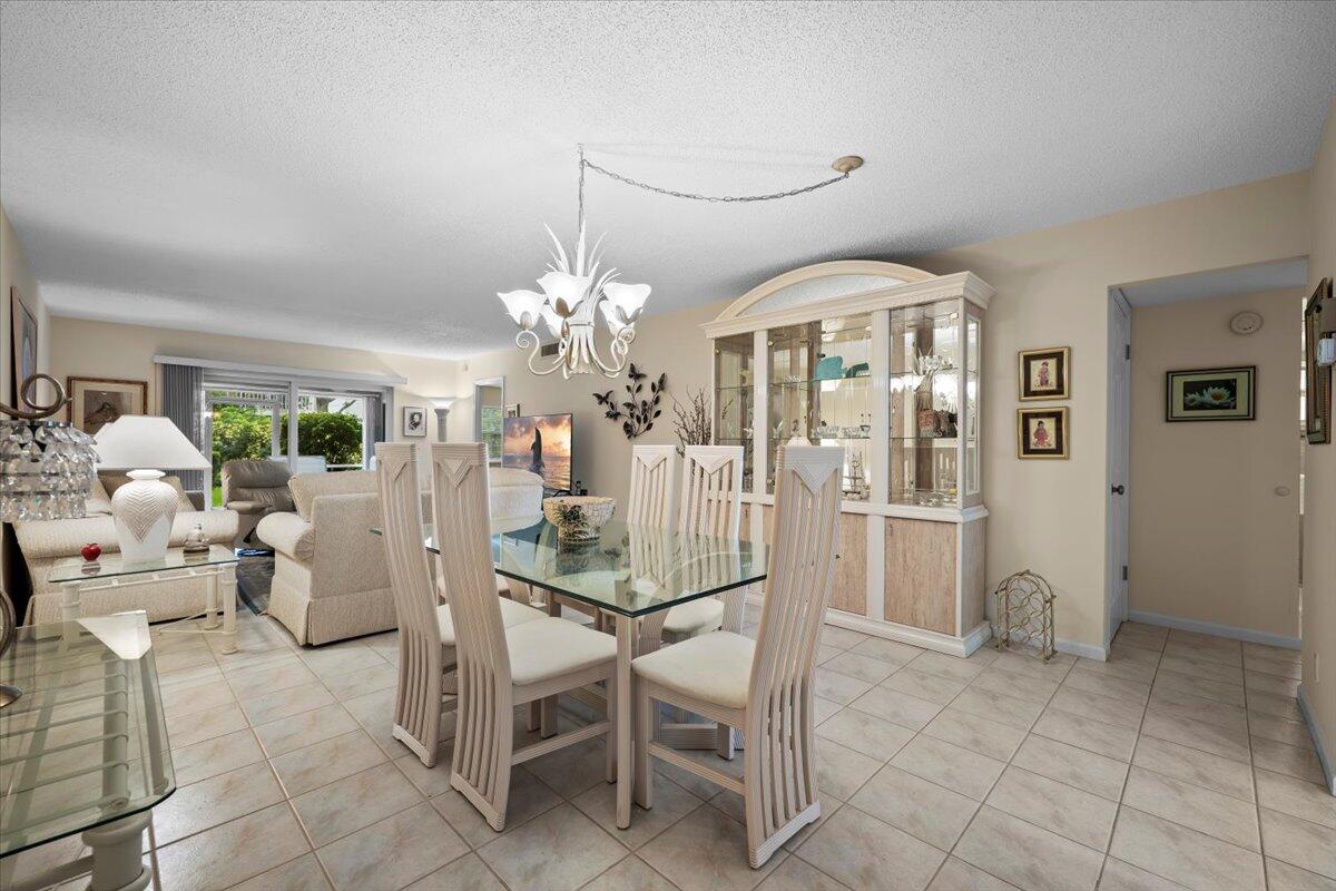 1252 Sugar Sands Boulevard, Unit 137 Riviera Beach, FL 33404 - Photo 8 of 38 a view of a livingroom with furniture and chandelier