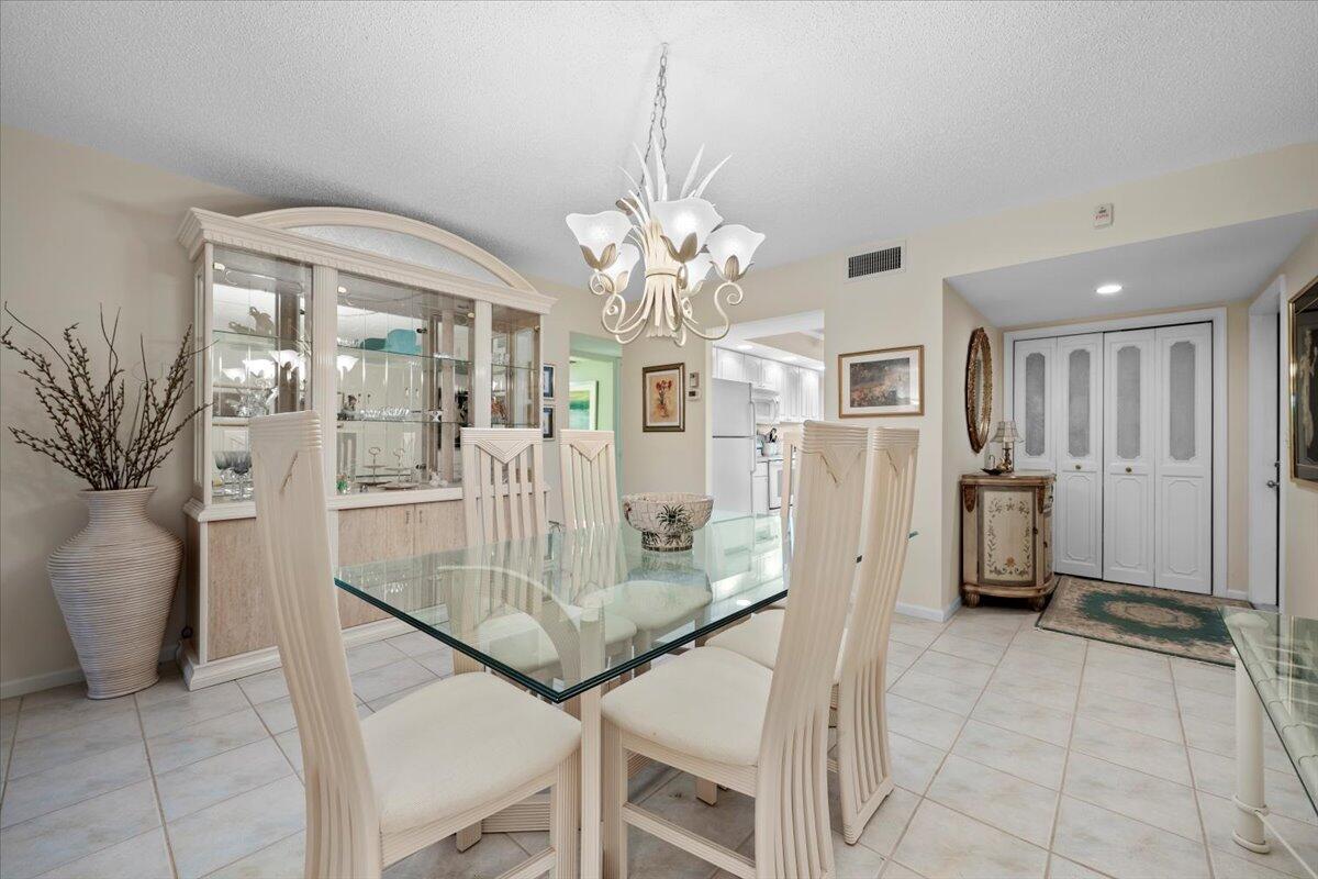 1252 Sugar Sands Boulevard, Unit 137 Riviera Beach, FL 33404 - Photo 9 of 38 a view of a livingroom with furniture and a chandelier