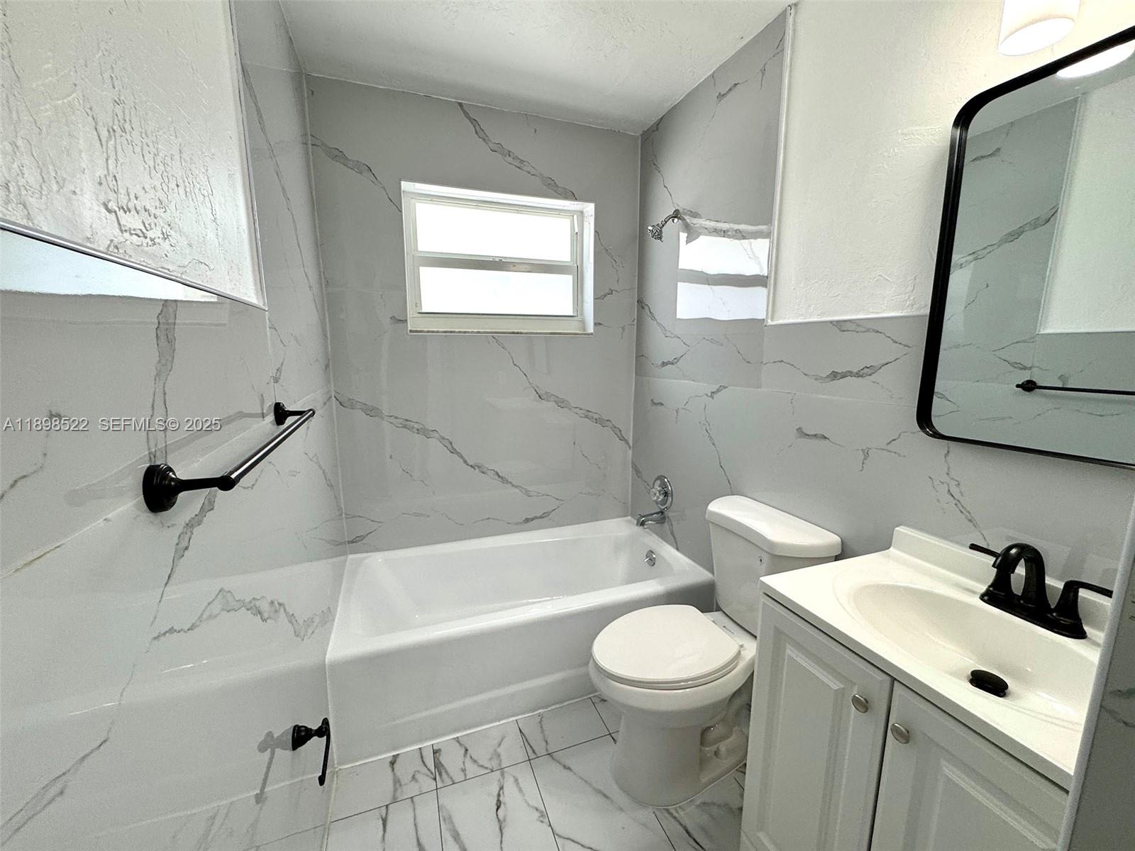 22712 Southwest 113th Place Miami, FL 33170 - Photo 8 of 15 a bathroom with a sink a toilet and bathtub