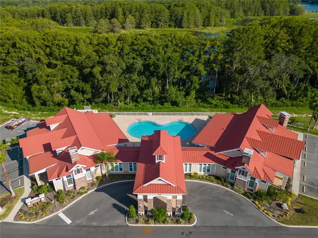 an aerial view of a house with garden space and street view