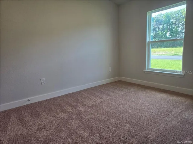 a large kitchen with cabinets and wooden floor