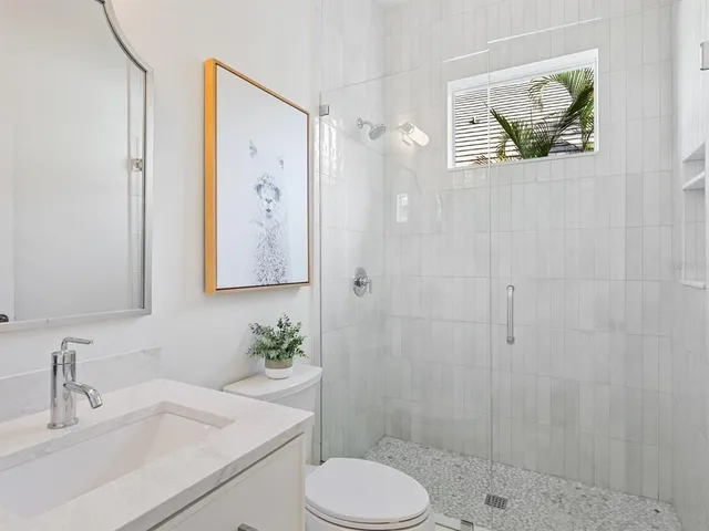 a bedroom with a bed lamp and a window