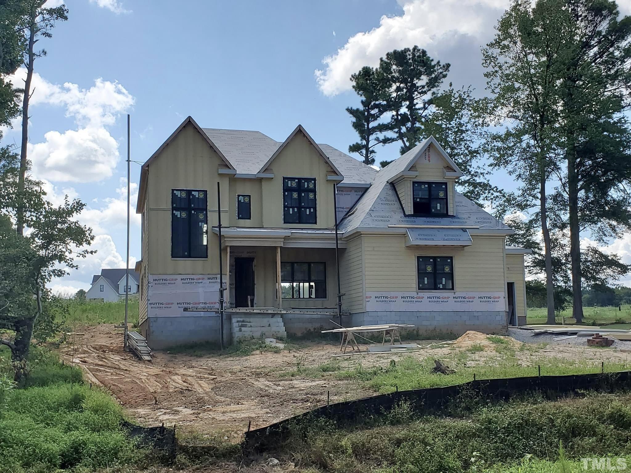1032 Harrison Ridge Road Wake Forest, NC 27587 - Photo 1 of 4 a front view of a house with garden