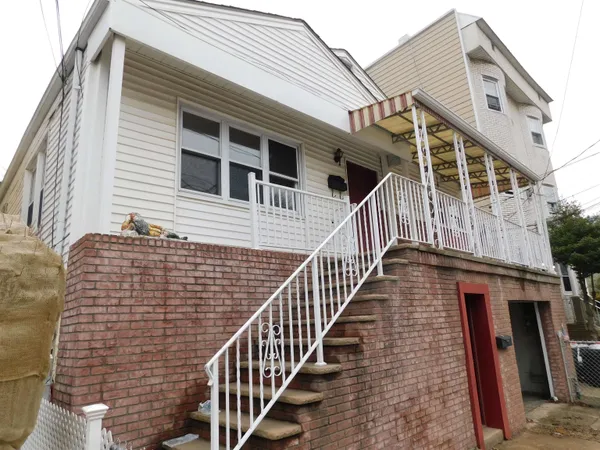 a front view of a house with wooden stairs