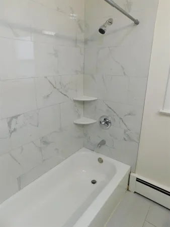 a bathroom with a bathtub and a shower