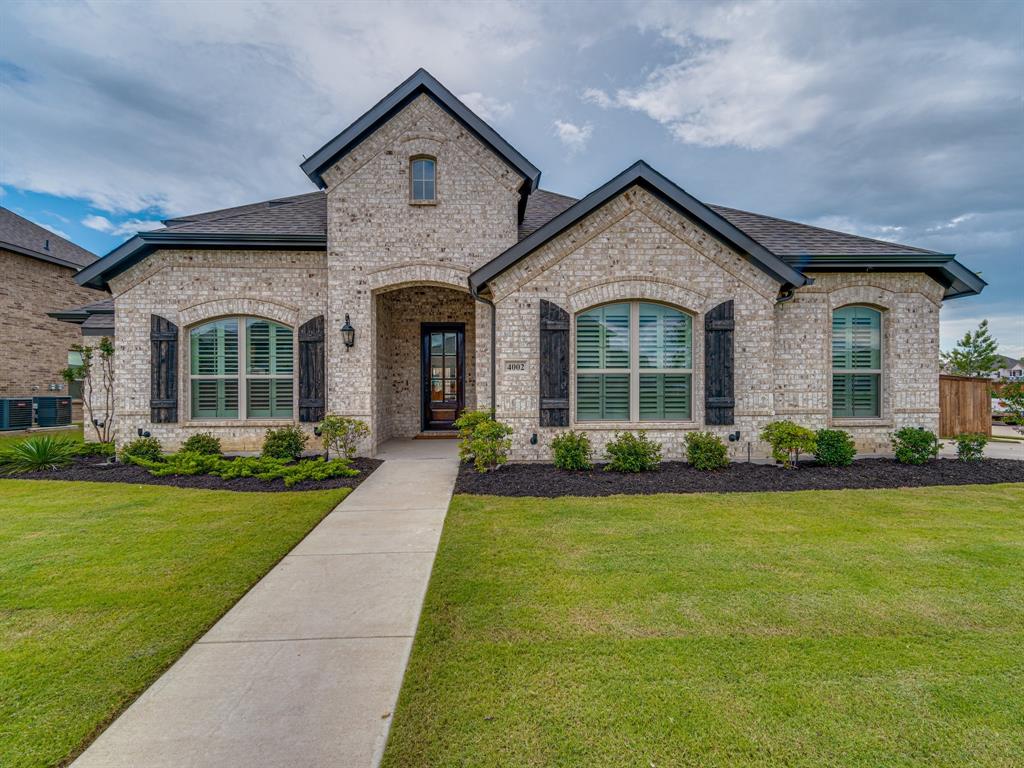 a front view of a house with garden and porch
