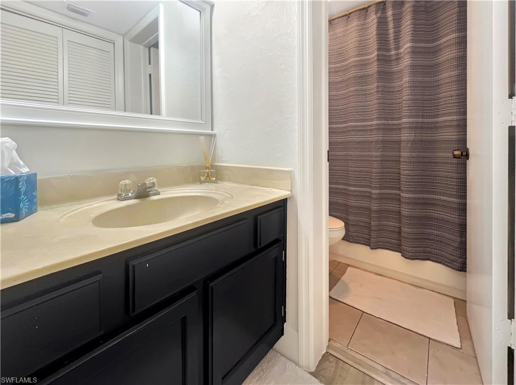 600 Neapolitan Way, Unit 342 Naples, FL 34103 - Photo 12 of 50 a bathroom with a sink and a mirror