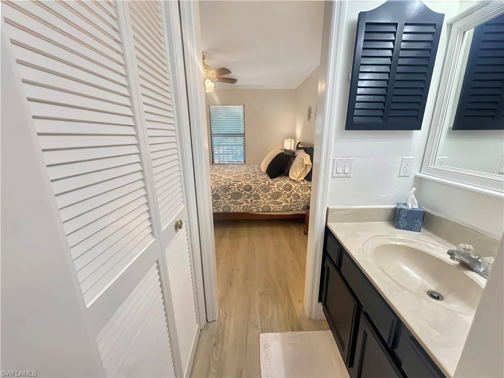 600 Neapolitan Way, Unit 342 Naples, FL 34103 - Photo 14 of 50 a bathroom with a sink a mirror and shower
