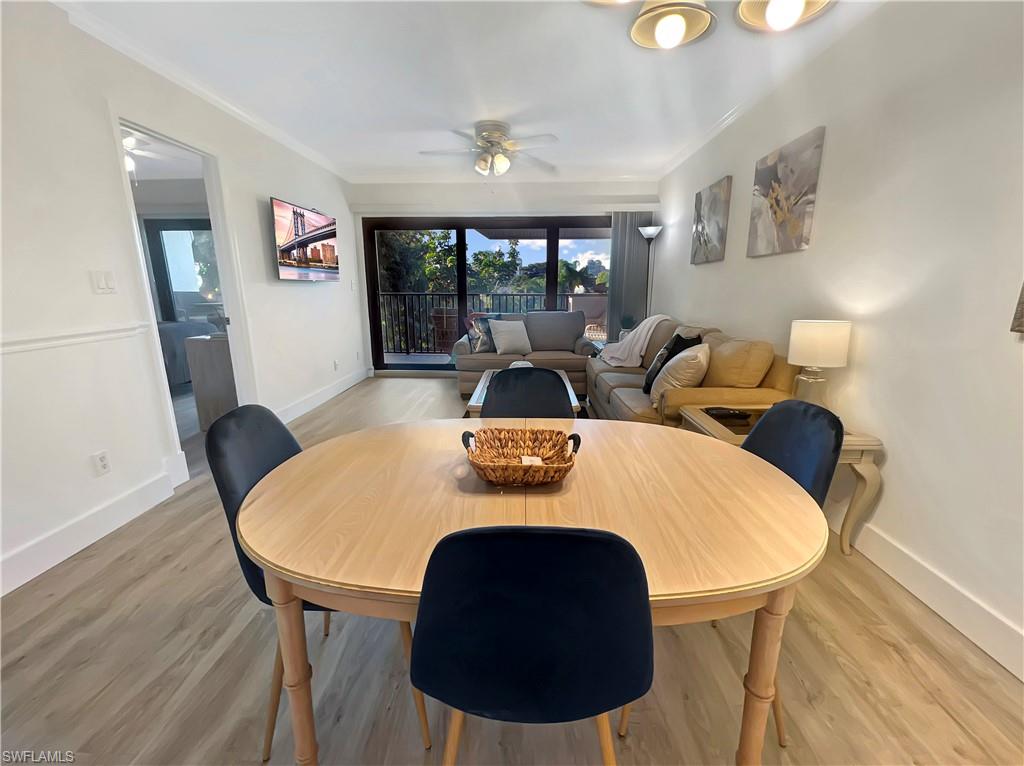 600 Neapolitan Way, Unit 342 Naples, FL 34103 - Photo 16 of 50 a view of a dining room with furniture and wooden floor
