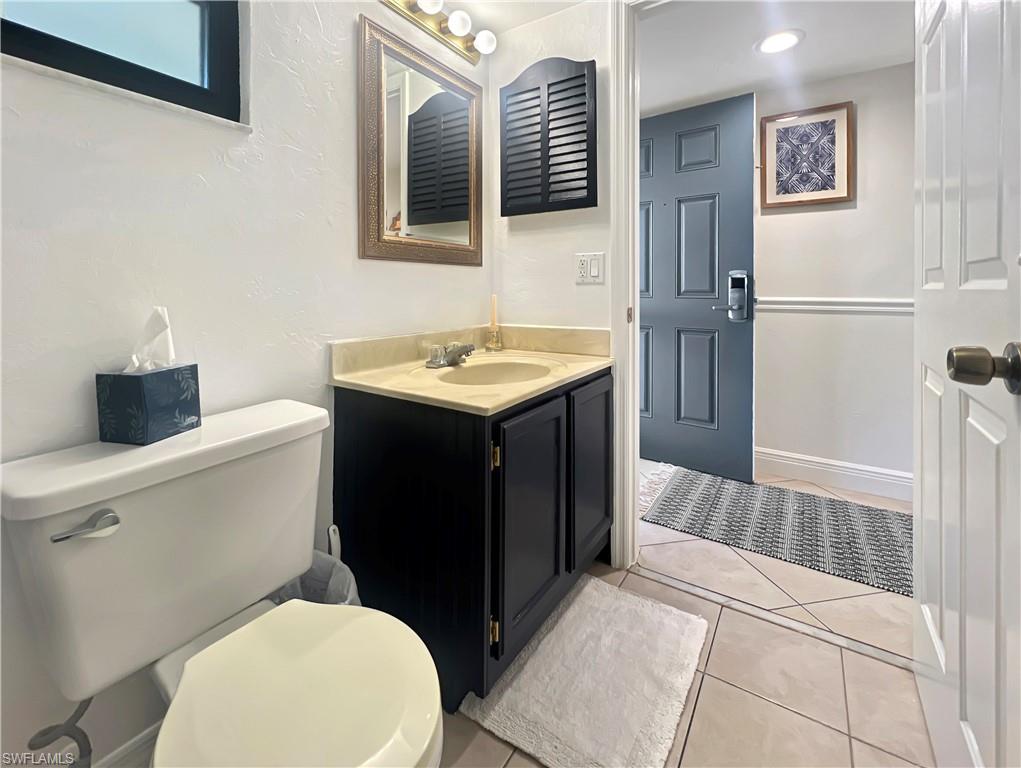 600 Neapolitan Way, Unit 342 Naples, FL 34103 - Photo 27 of 50 a bathroom with a sink toilet and mirror