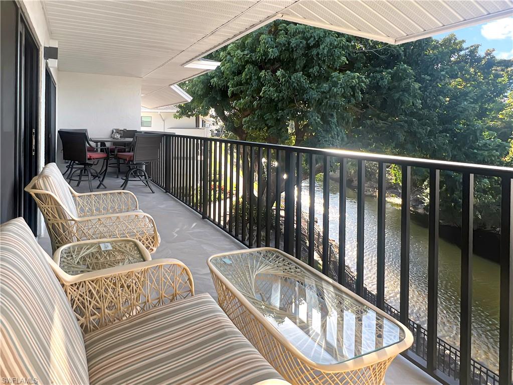 600 Neapolitan Way, Unit 342 Naples, FL 34103 - Photo 28 of 50 a view of a balcony with furniture