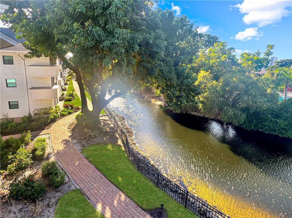 600 Neapolitan Way, Unit 342 Naples, FL 34103 - Photo 32 of 50 a view of a lake with a yard