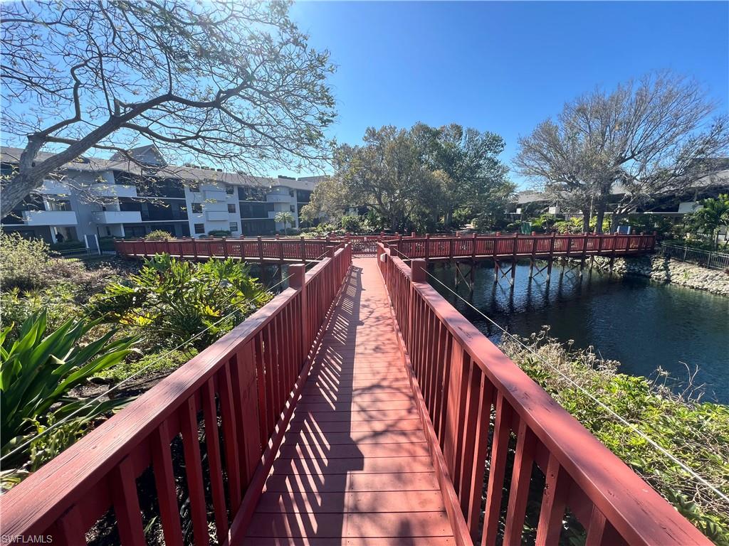 600 Neapolitan Way, Unit 342 Naples, FL 34103 - Photo 41 of 50 a balcony with wooden floor and lake view
