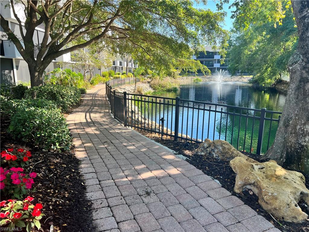 600 Neapolitan Way, Unit 342 Naples, FL 34103 - Photo 43 of 50 a view of a pathway with a wrought fence