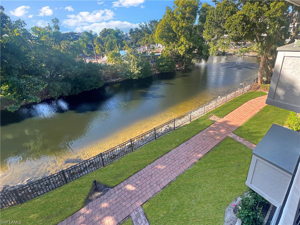 600 Neapolitan Way, Unit 342 Naples, FL 34103 - Photo 49 of 50 a view of a lake with a yard