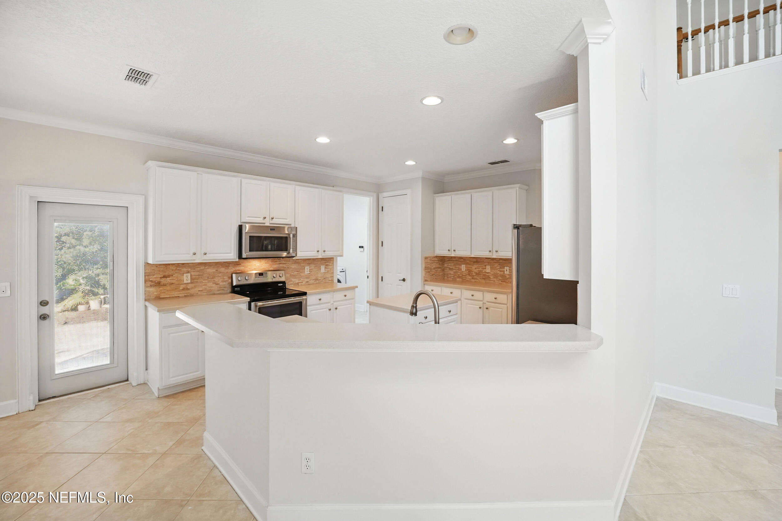 105 2nd Street St. Augustine, FL 32084 - Photo 18 of 61 a kitchen with stainless steel appliances a refrigerator sink and microwave