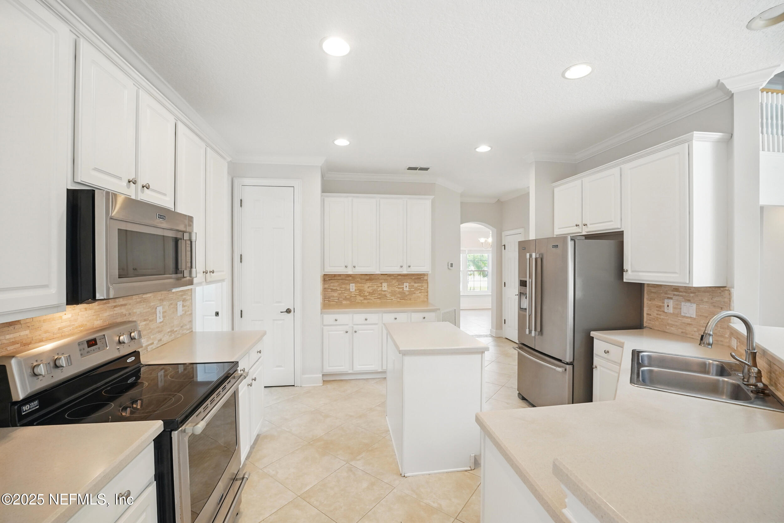 105 2nd Street St. Augustine, FL 32084 - Photo 19 of 61 a kitchen with stainless steel appliances a refrigerator a stove a microwave a sink and cabinets