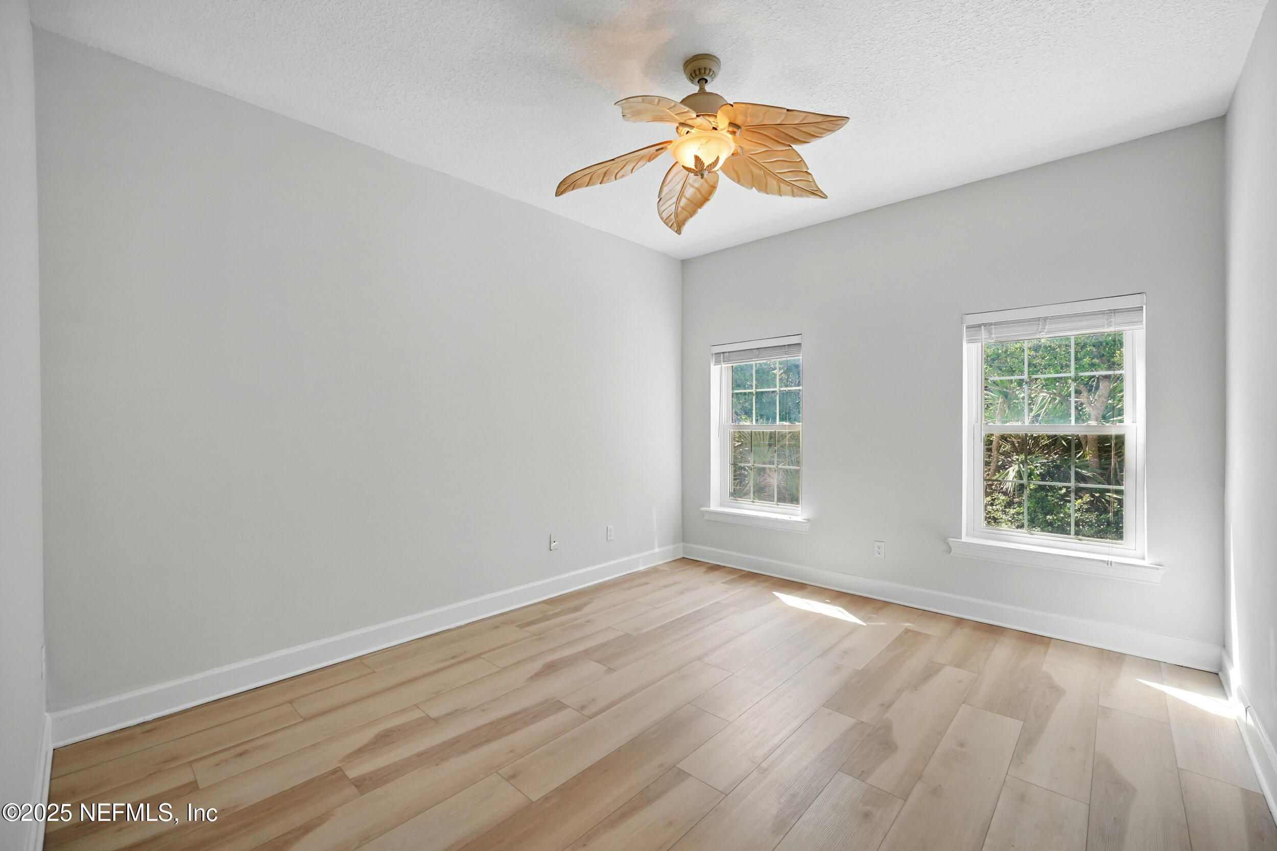105 2nd Street St. Augustine, FL 32084 - Photo 24 of 61 a view of an empty room with wooden floor and a window