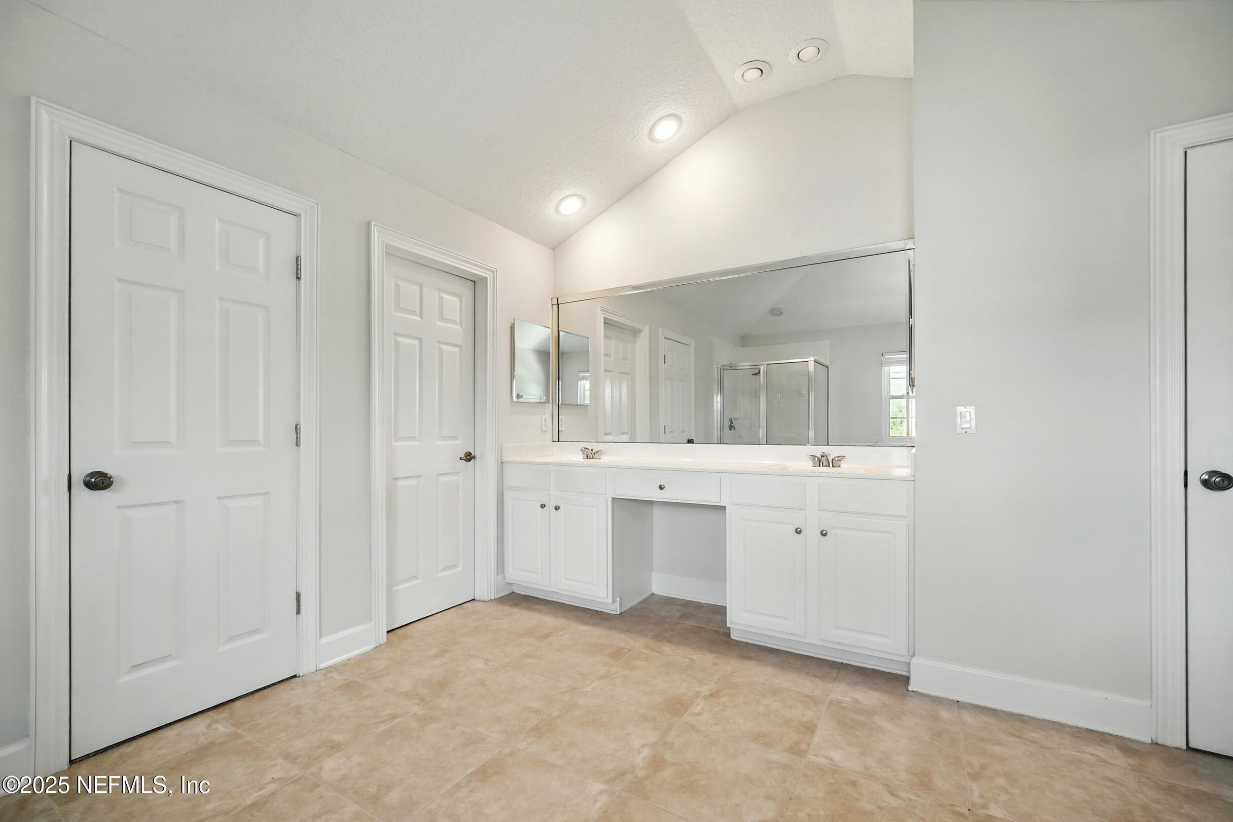 105 2nd Street St. Augustine, FL 32084 - Photo 32 of 61 a bathroom with a granite countertop sink and mirror