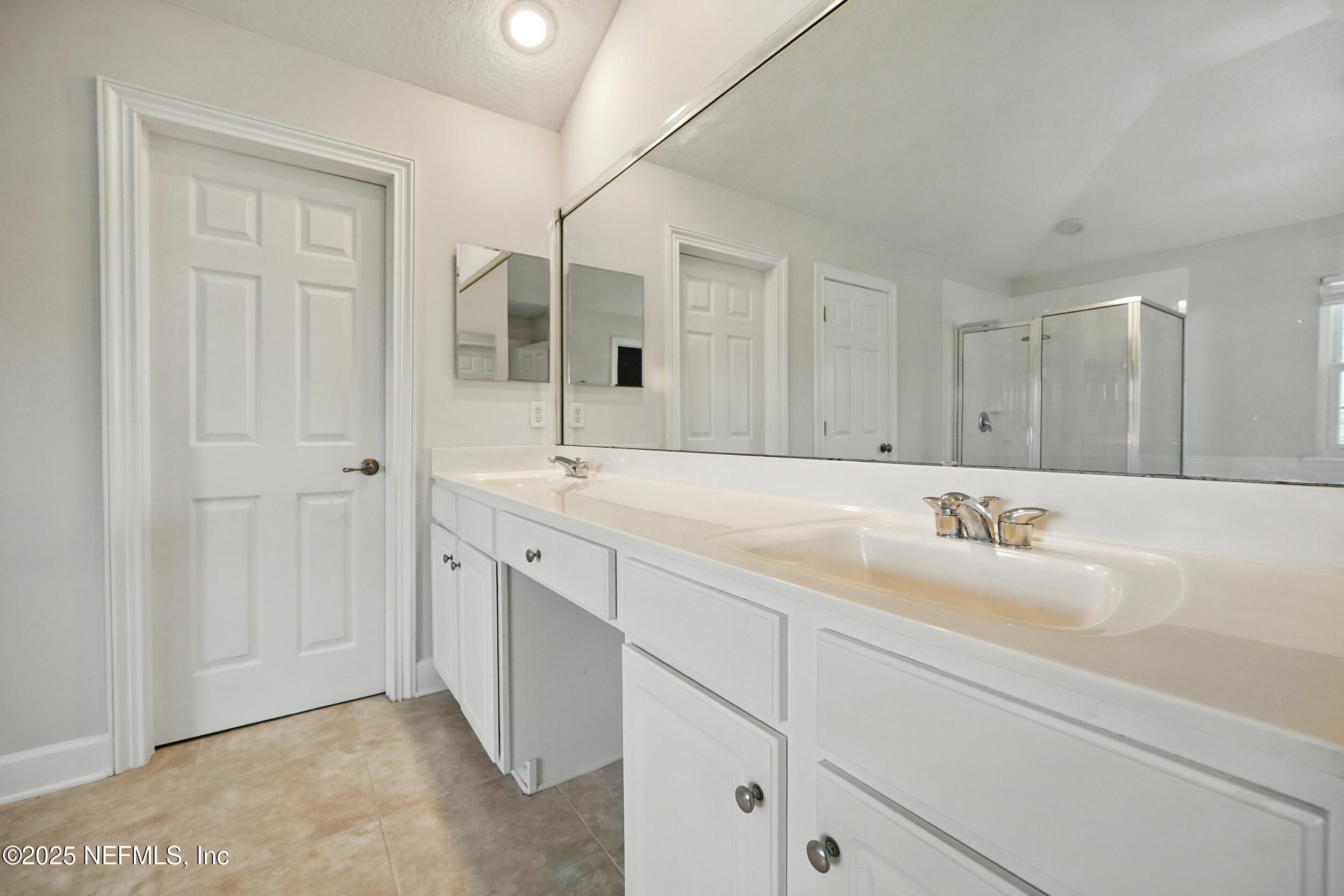 105 2nd Street St. Augustine, FL 32084 - Photo 33 of 61 a bathroom with double sink and a mirror