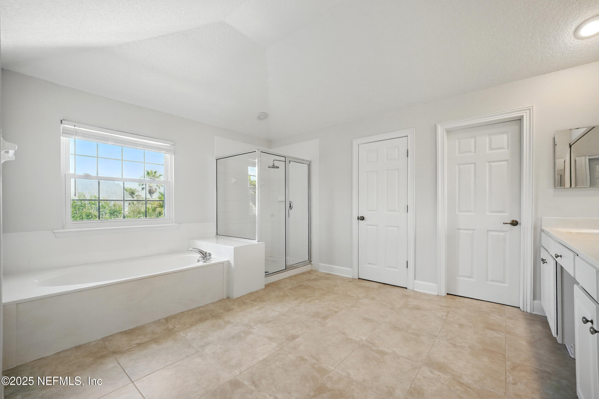 105 2nd Street St. Augustine, FL 32084 - Photo 34 of 61 a spacious bathroom with a bathtub and a shower