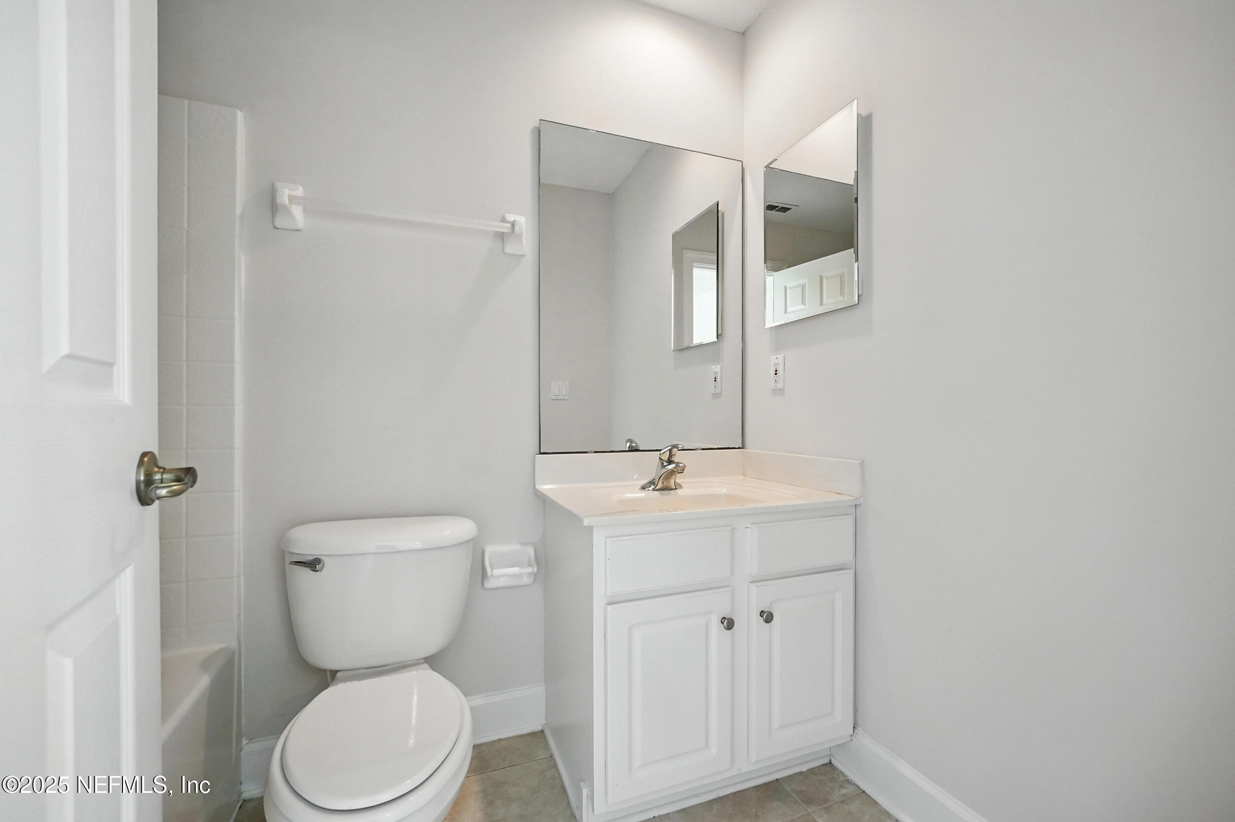 105 2nd Street St. Augustine, FL 32084 - Photo 41 of 61 a bathroom with a toilet sink and mirror