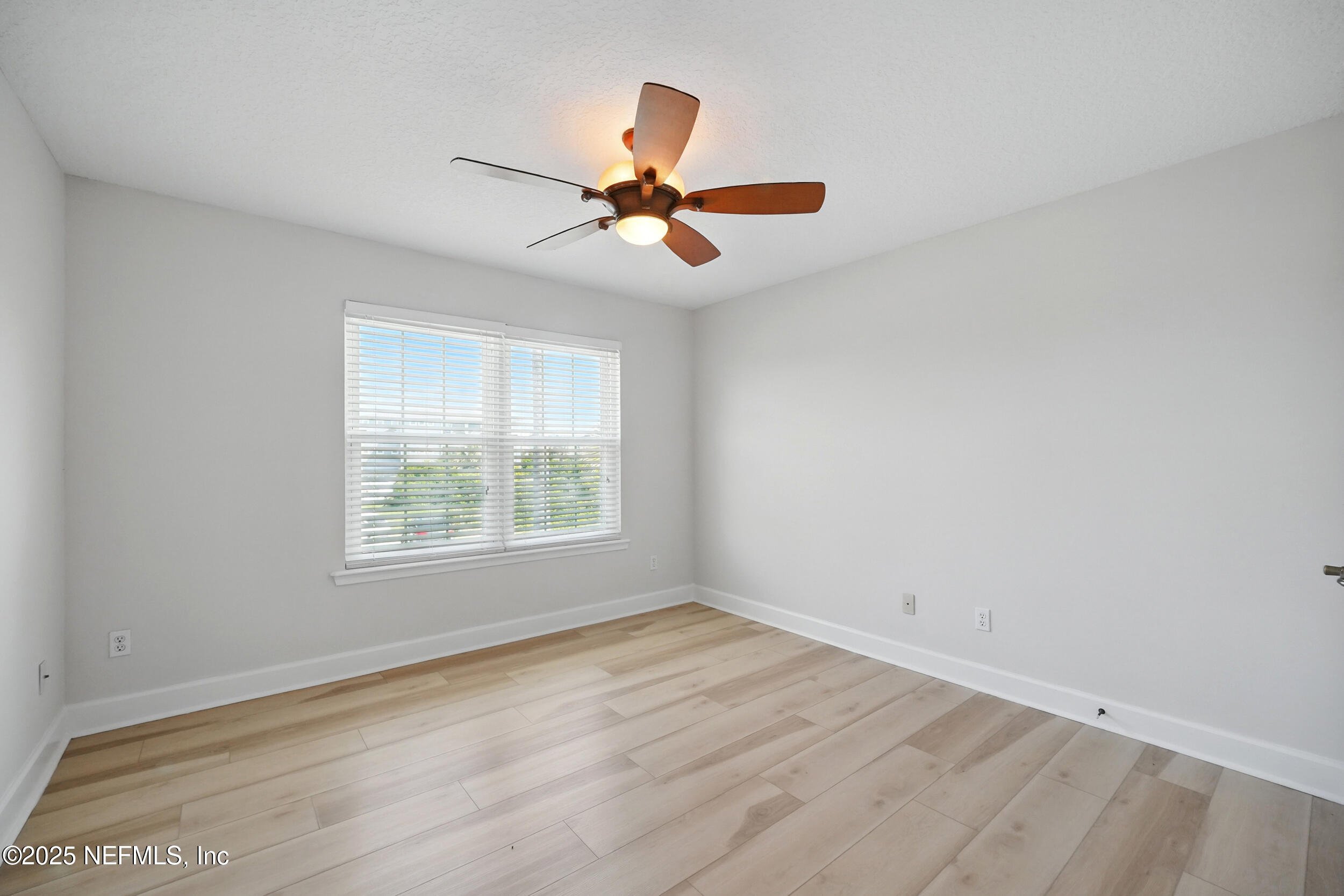 105 2nd Street St. Augustine, FL 32084 - Photo 46 of 61 an empty room with wooden floor ceiling fan and window
