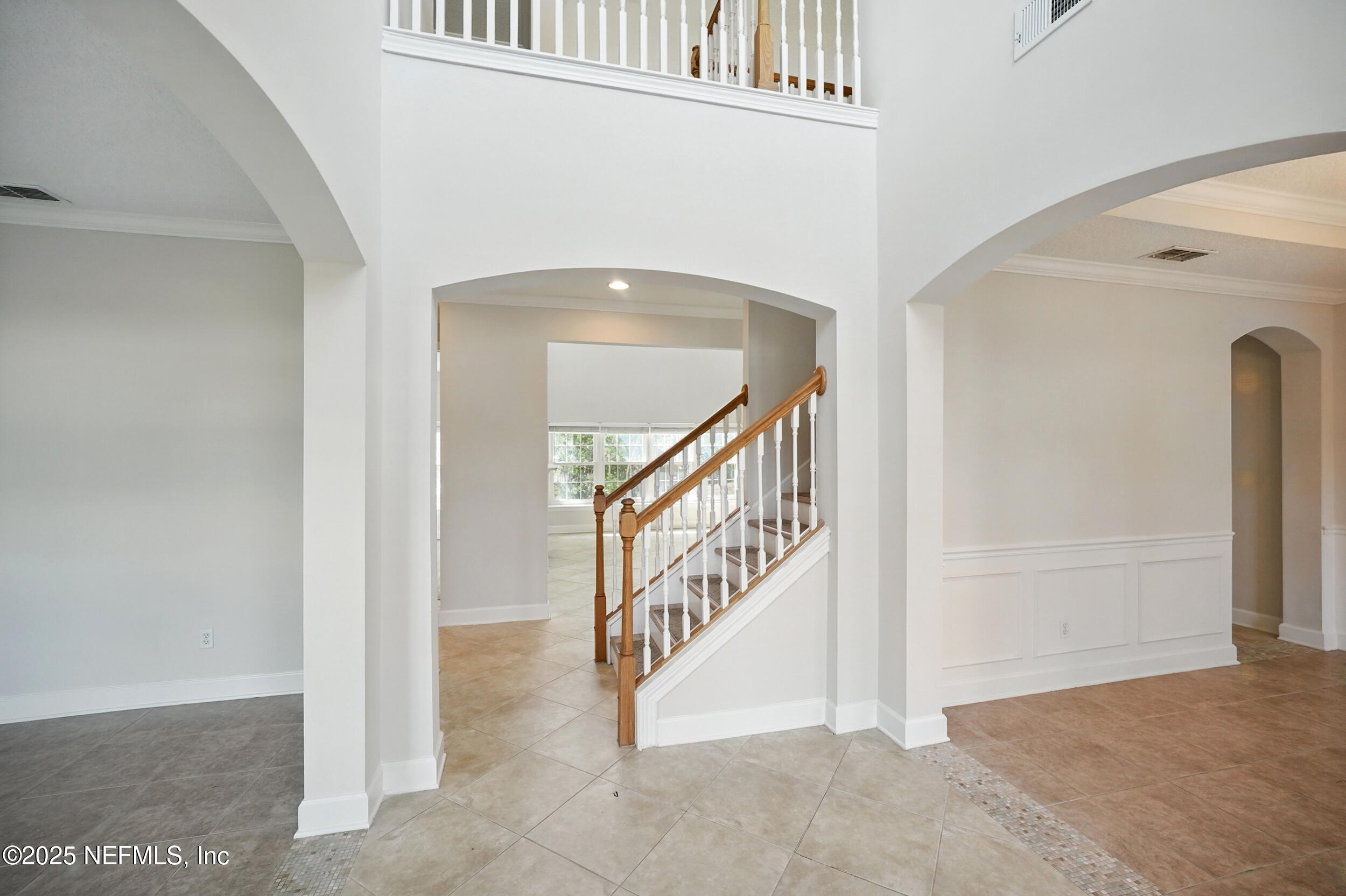 105 2nd Street St. Augustine, FL 32084 - Photo 6 of 61 a view of staircase with white walls and windows