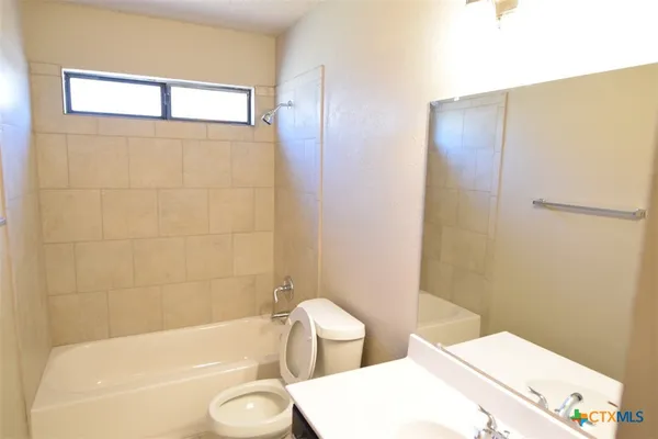 a bathroom with a toilet and a tub