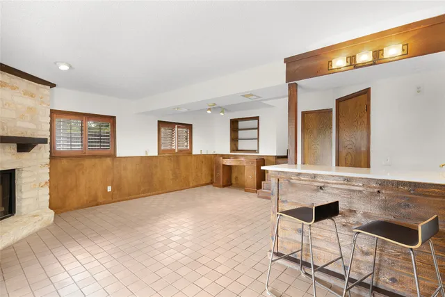 a view of empty room with fireplace and windows