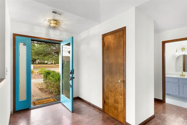 a kitchen with white cabinets and appliances