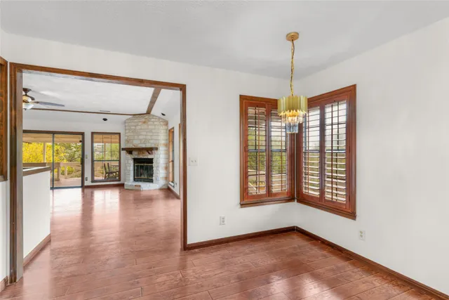 a living room with stainless steel appliances granite countertop furniture a fireplace and a large window